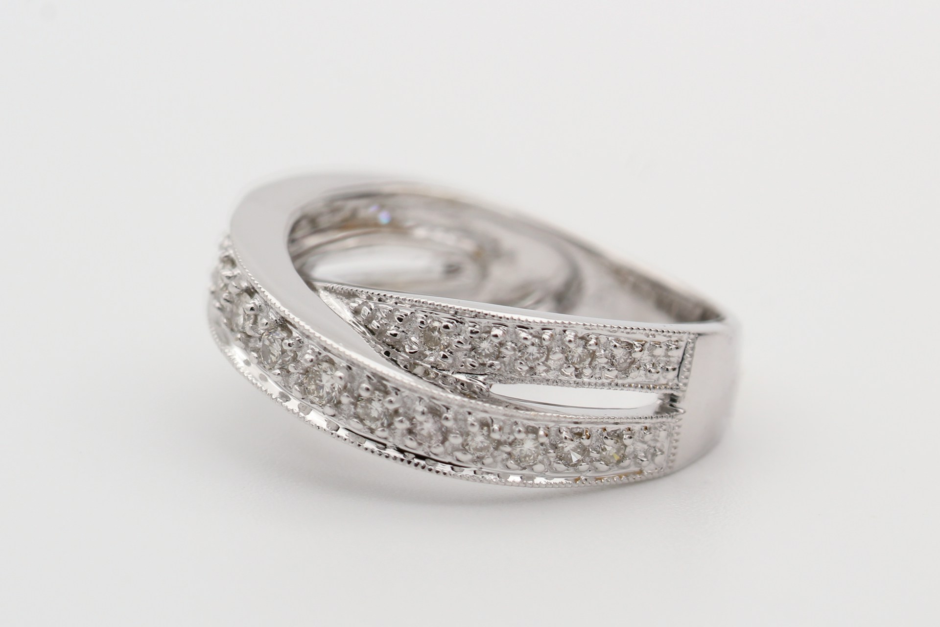 a platinum fashion ring on a gray background