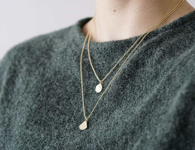 woman wearing layered necklaces