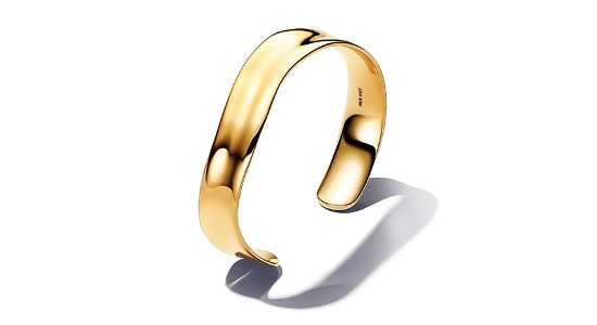 a yellow gold sculptural cuff bracelet by Pandora