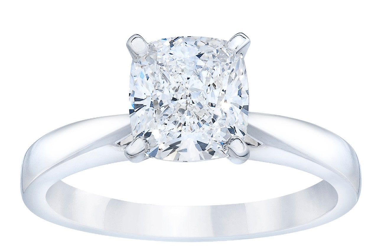 close up image of a white gold engagement ring with a cushion cut diamond