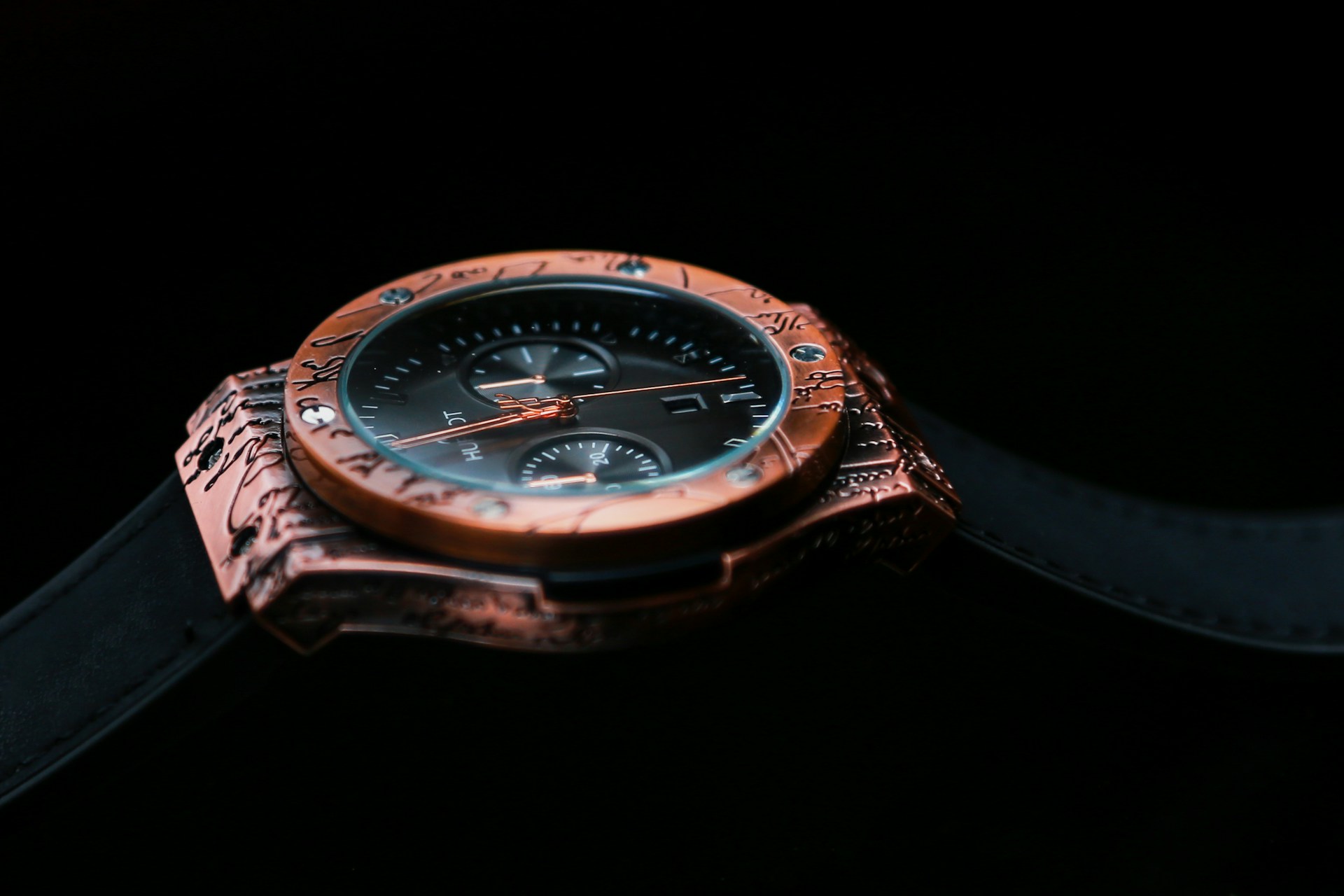 A close-up of a unique vintage-style wristwatch on a black backdrop.