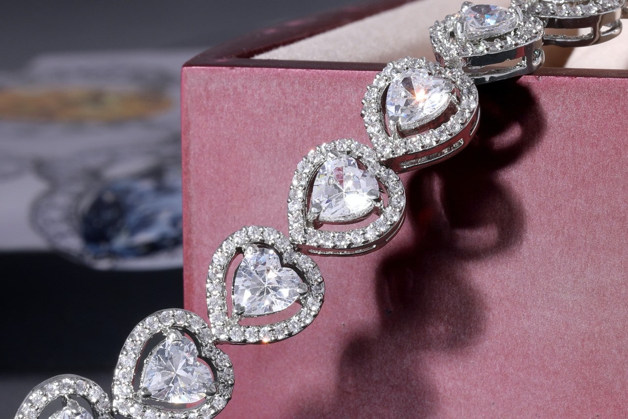 A necklace with heart shaped diamonds surrounded in diamond halos