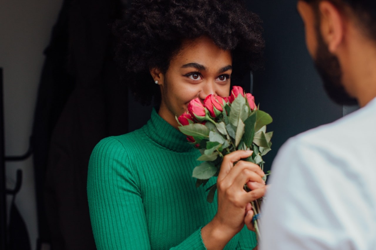 Fashionable lady savoring a bouquet of roses