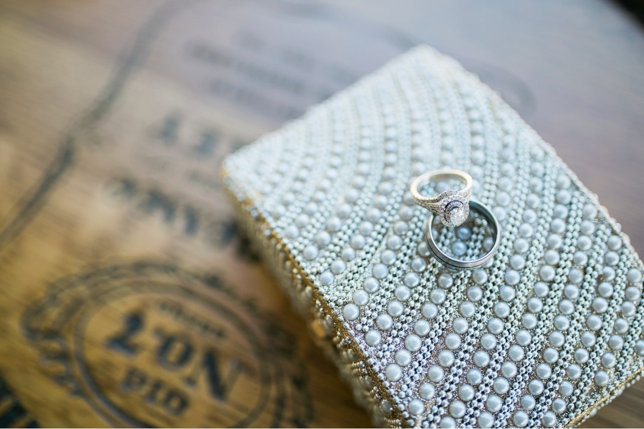 Engagement ring with two diamond halos balancing on top of a wedding band