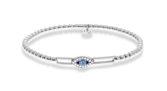 Close up image of a silver bangle with beaded detail and a blue evil eye motif