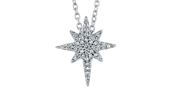 A silver pendant necklace featuring a star shaped pendant filled with round cut diamonds