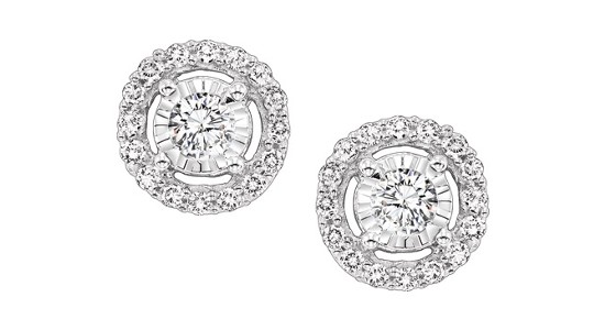 A pair of silver diamond stud earrings with round cut center stones and halo settings