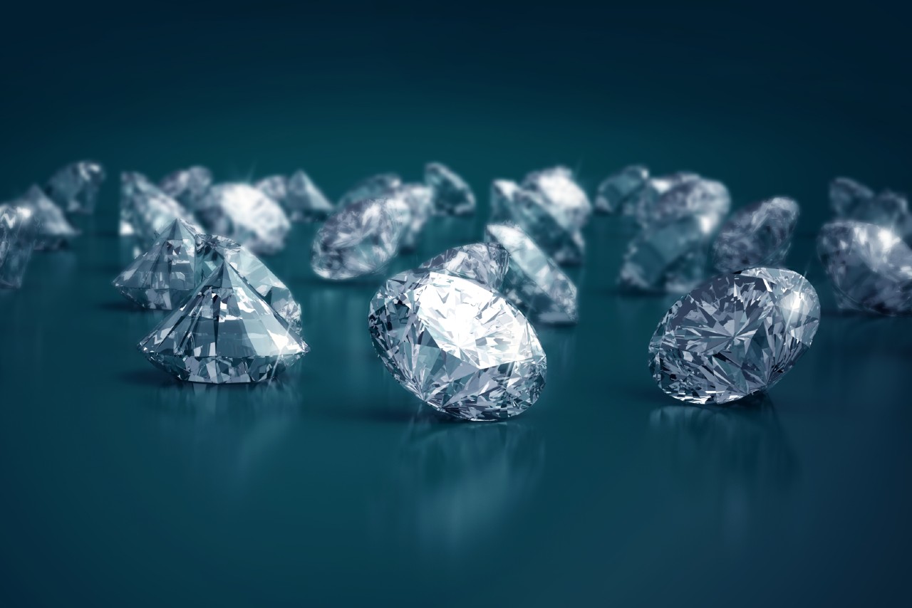 An ensemble of lab-grown diamonds sits on a dark blue background