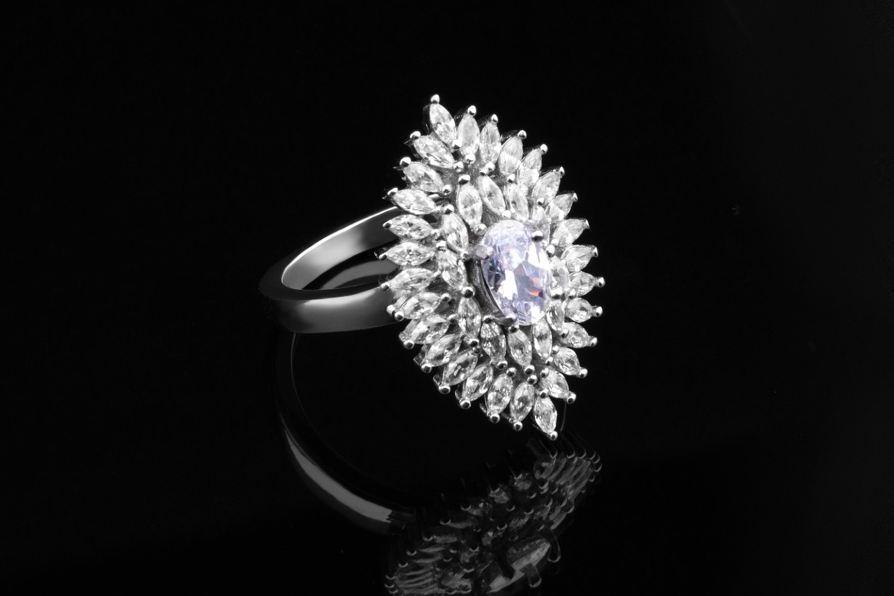 Platinum fashion ring with intricate diamond halo.