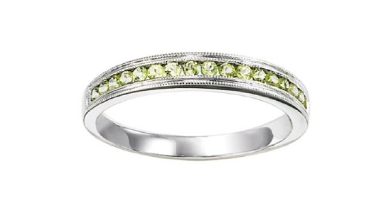 A silver, channel setting stackable fashion ring with a row of peridots