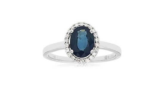 a silver fashion ring featuring an oval cut sapphire and a diamond halo
