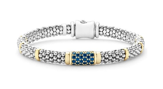 a silver textured bracelet featuring yellow gold details and tiny round cut sapphires