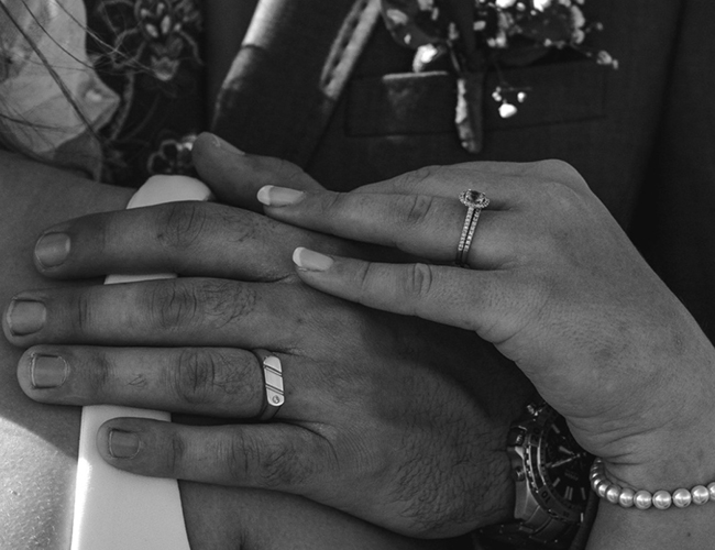 man and woman holding each other wearing their wedding rings