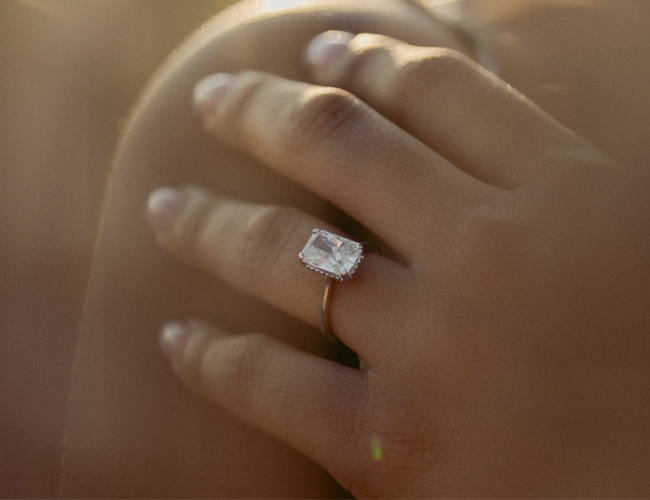 woman wearing radiant engagement ring on her hand