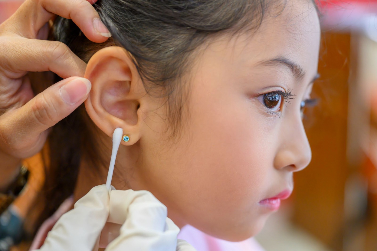 girl getting her ear pierced